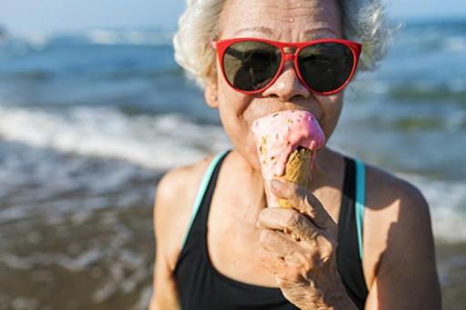 Grandma enjoying an ice cream cone on the beach